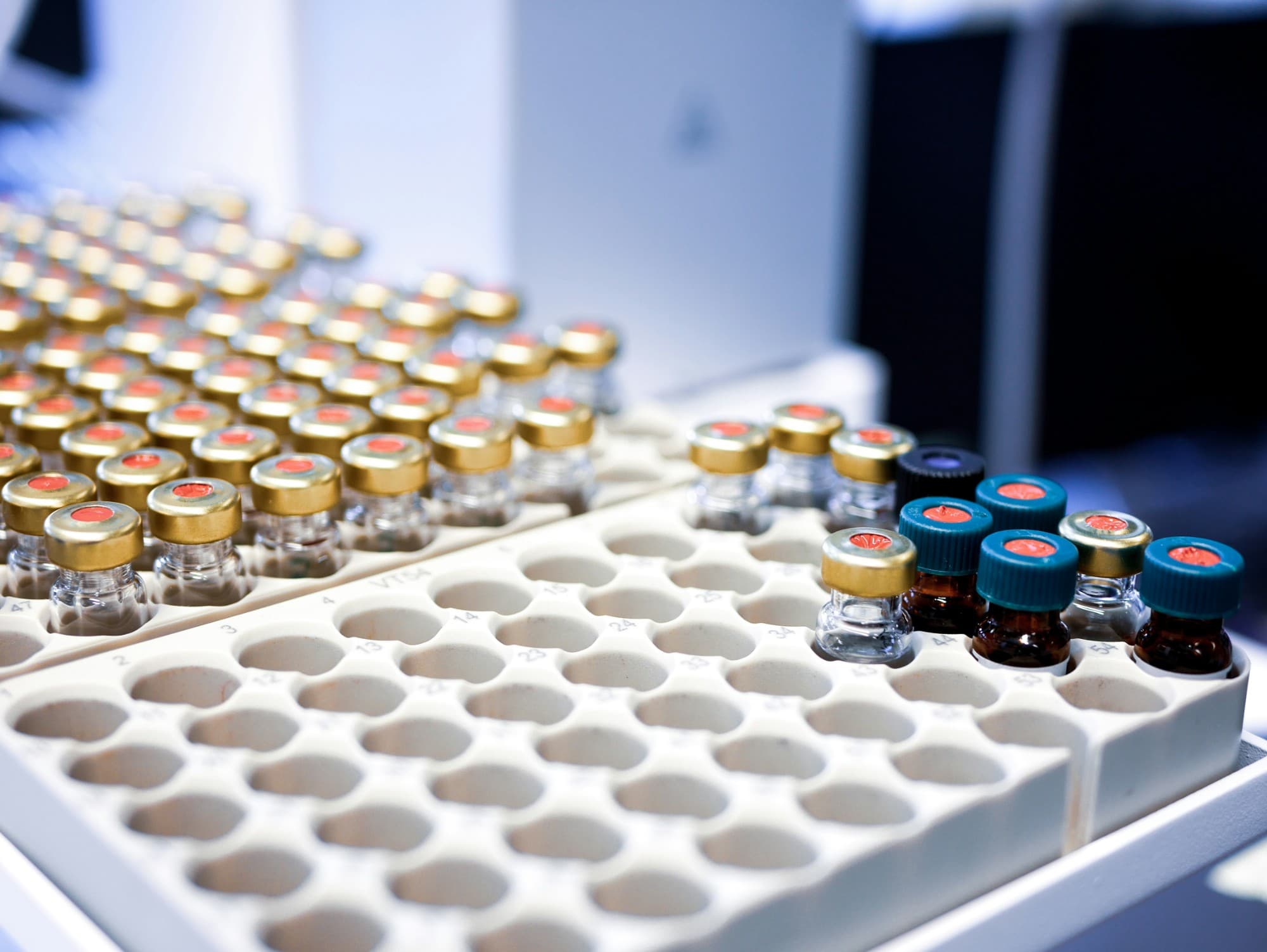 Capped vials held in a rack on a laboratory bench